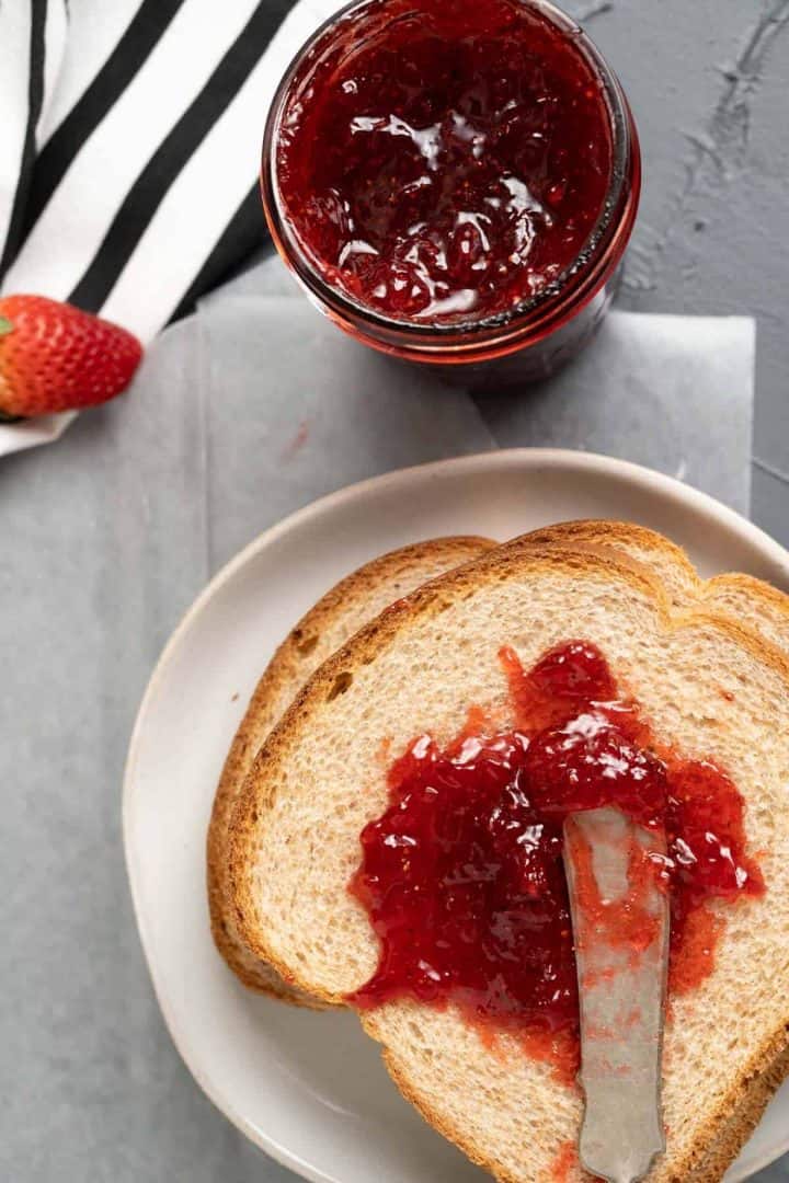 Strawberry jam on the wheat bread slice.