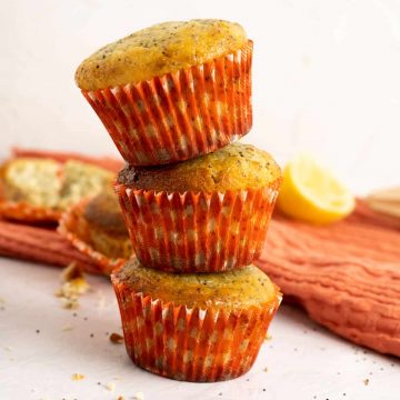 Lemon Poppy Seed Muffins stacked on one another.