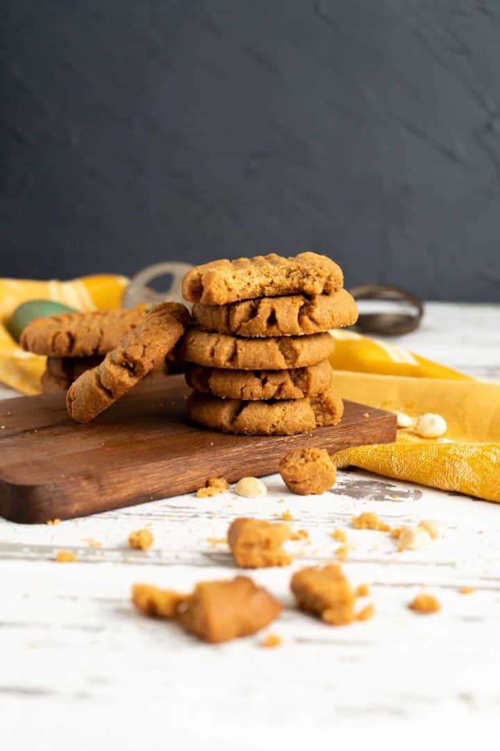 Peanut butter cookies stacking together on the board.