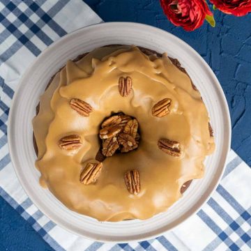 over the head shot of the Southern Pecan Praline Bundt Cake on blue and white table cloth.