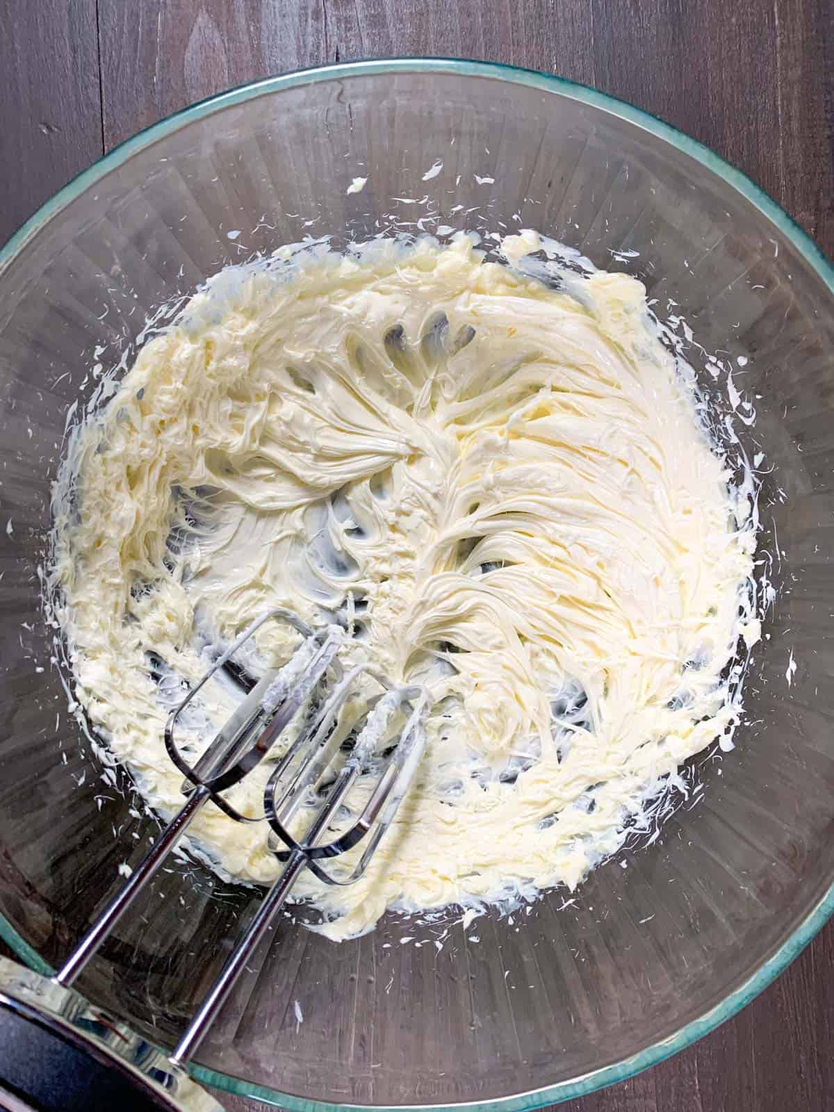 beating butter in a large bowl.