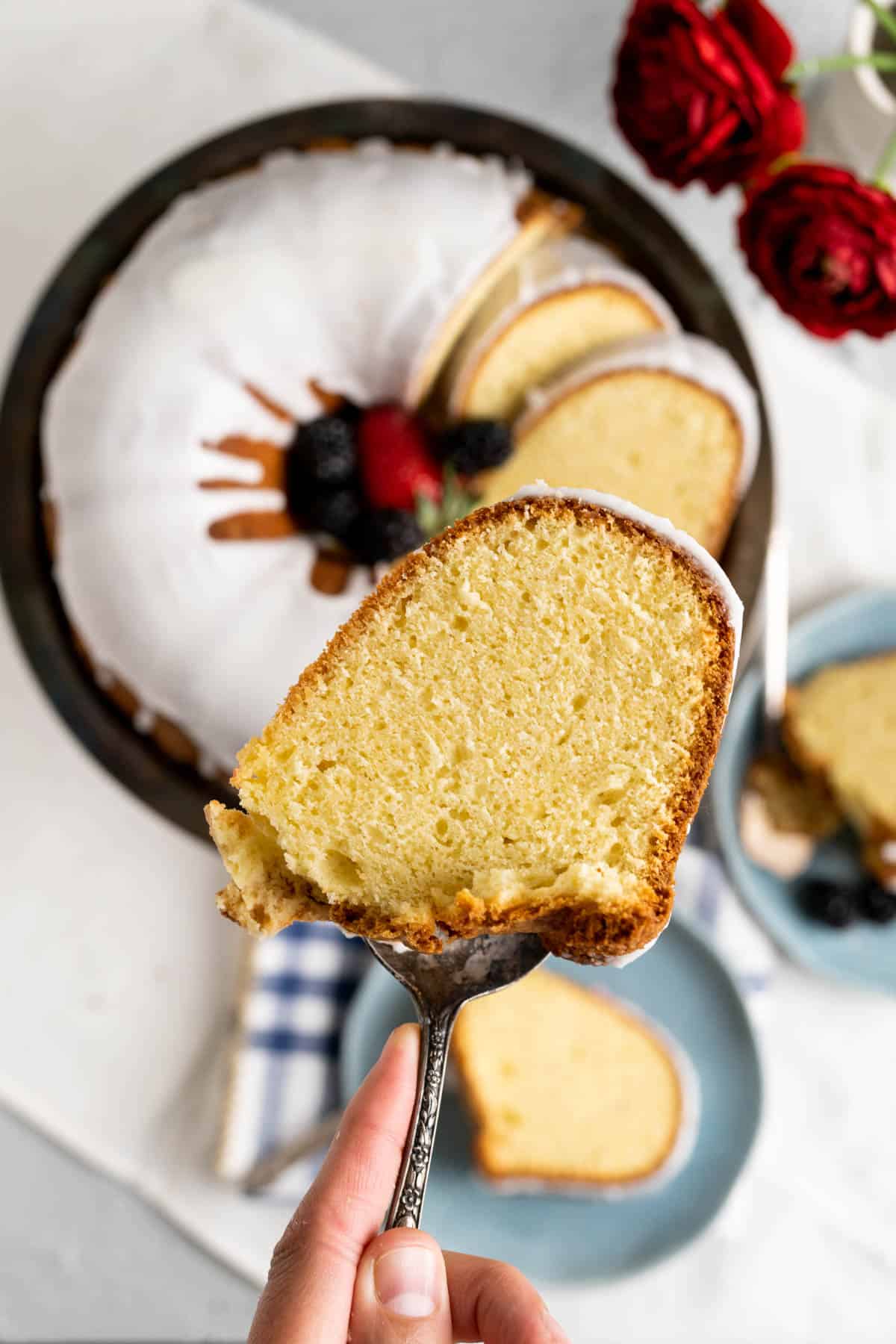 A cake piece of the sour cream pound cake with lemon icing on it. 