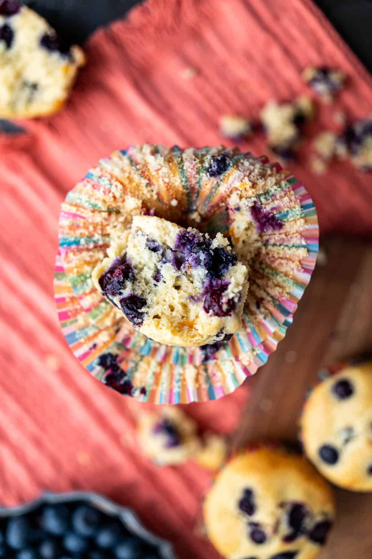 overhead shot of half opened old-fashioned blueberry muffin placed on a stand.