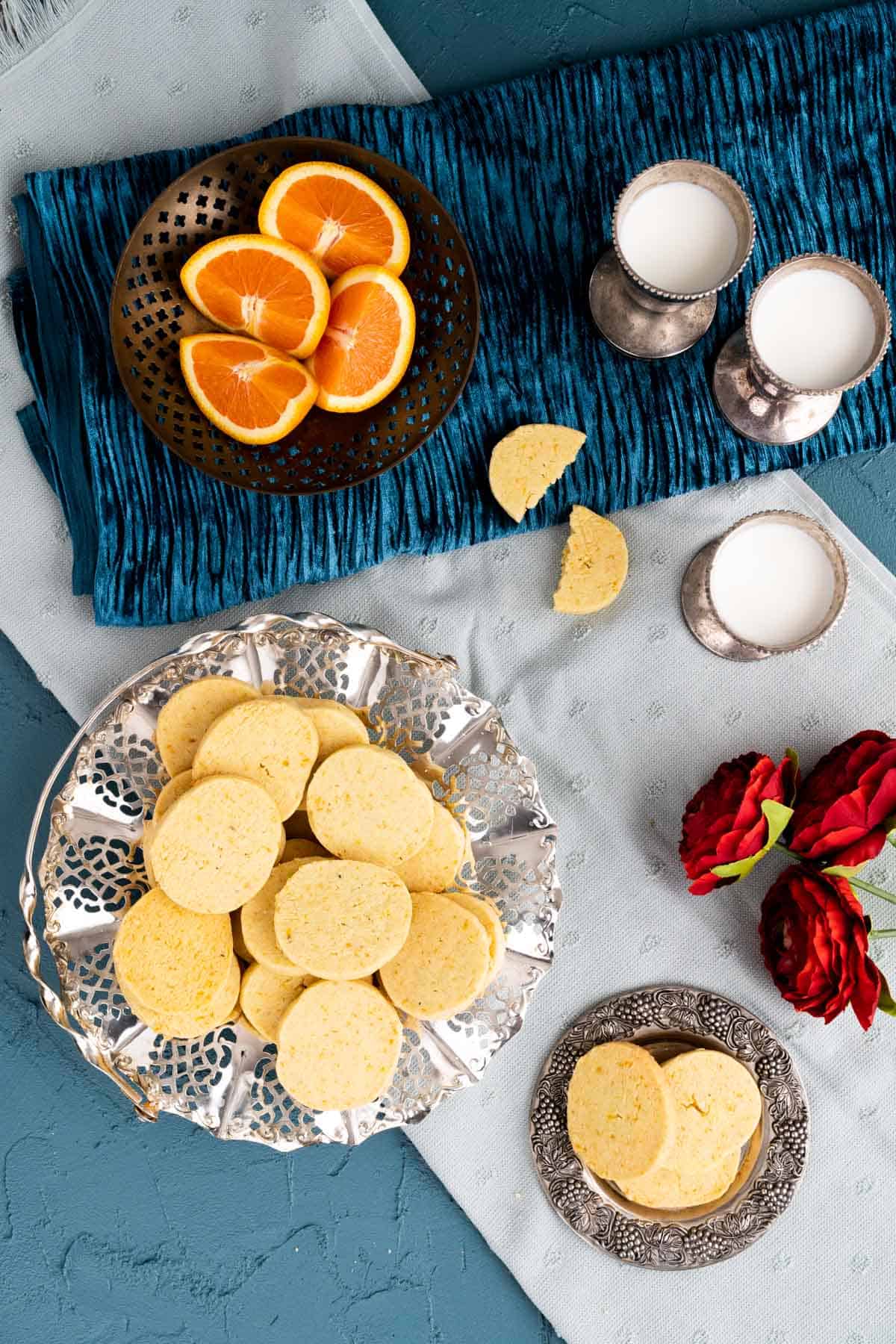 over the head shot showcasing the orange shortbread cookies in silver plate. 