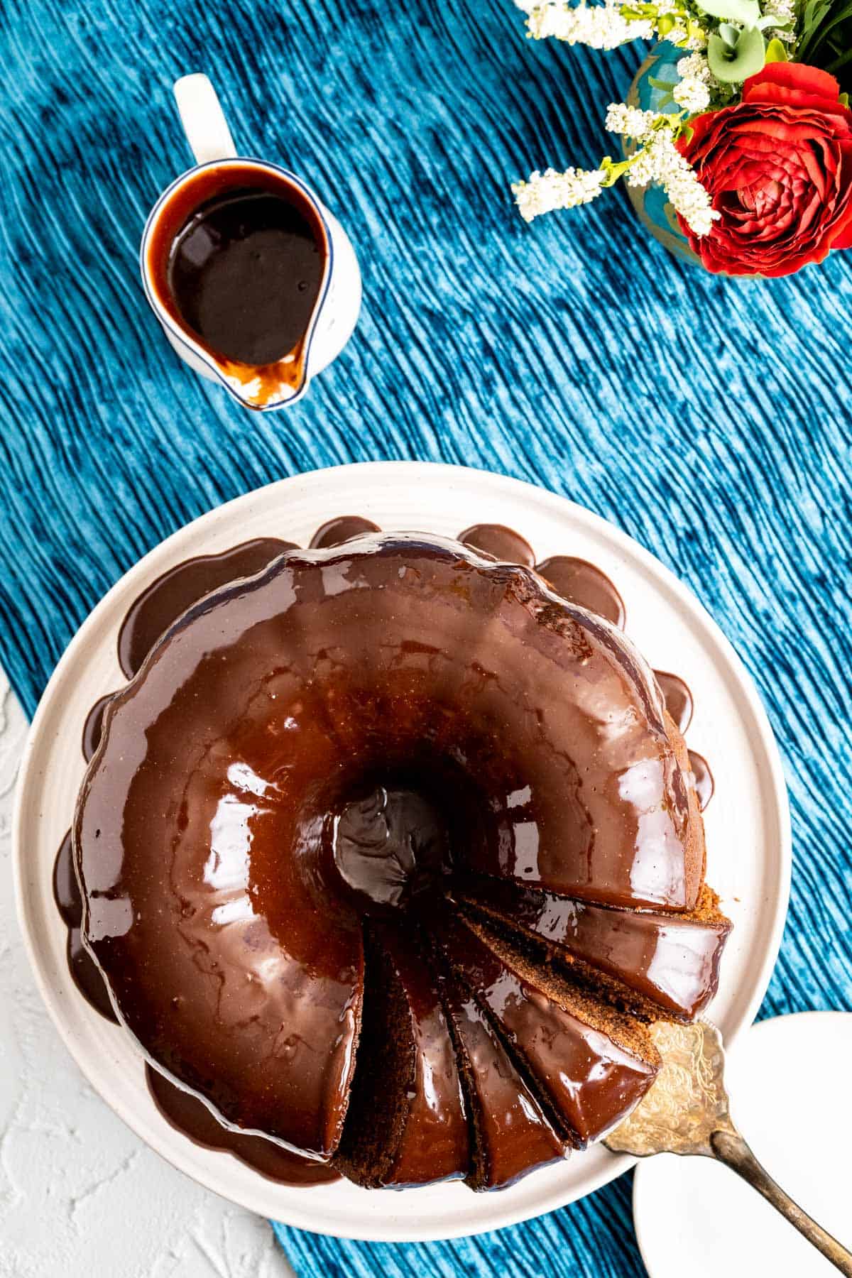 over head shot of the chocolate sour cream pound cake with chocolate ganache in a small pitcher.