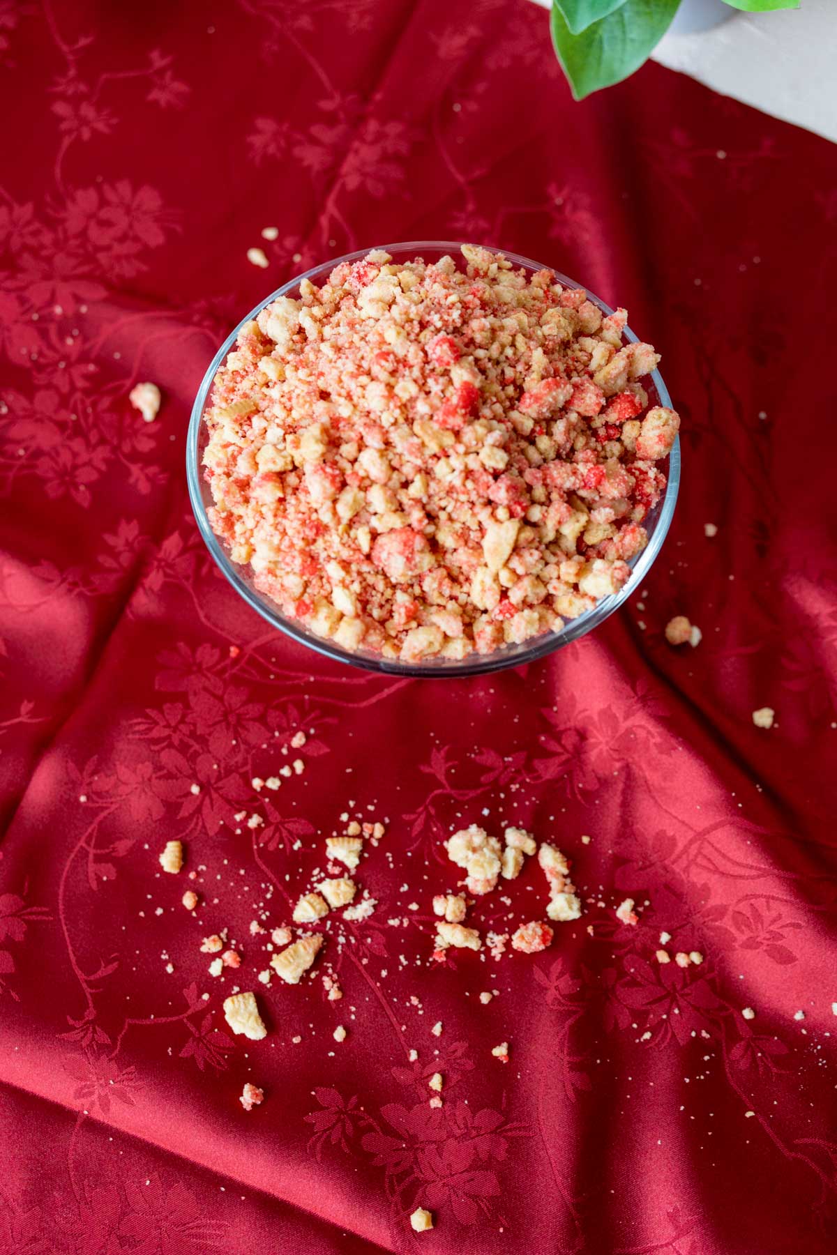 over head shot of strawberry crunch topping in a bowl with crunch spread around.