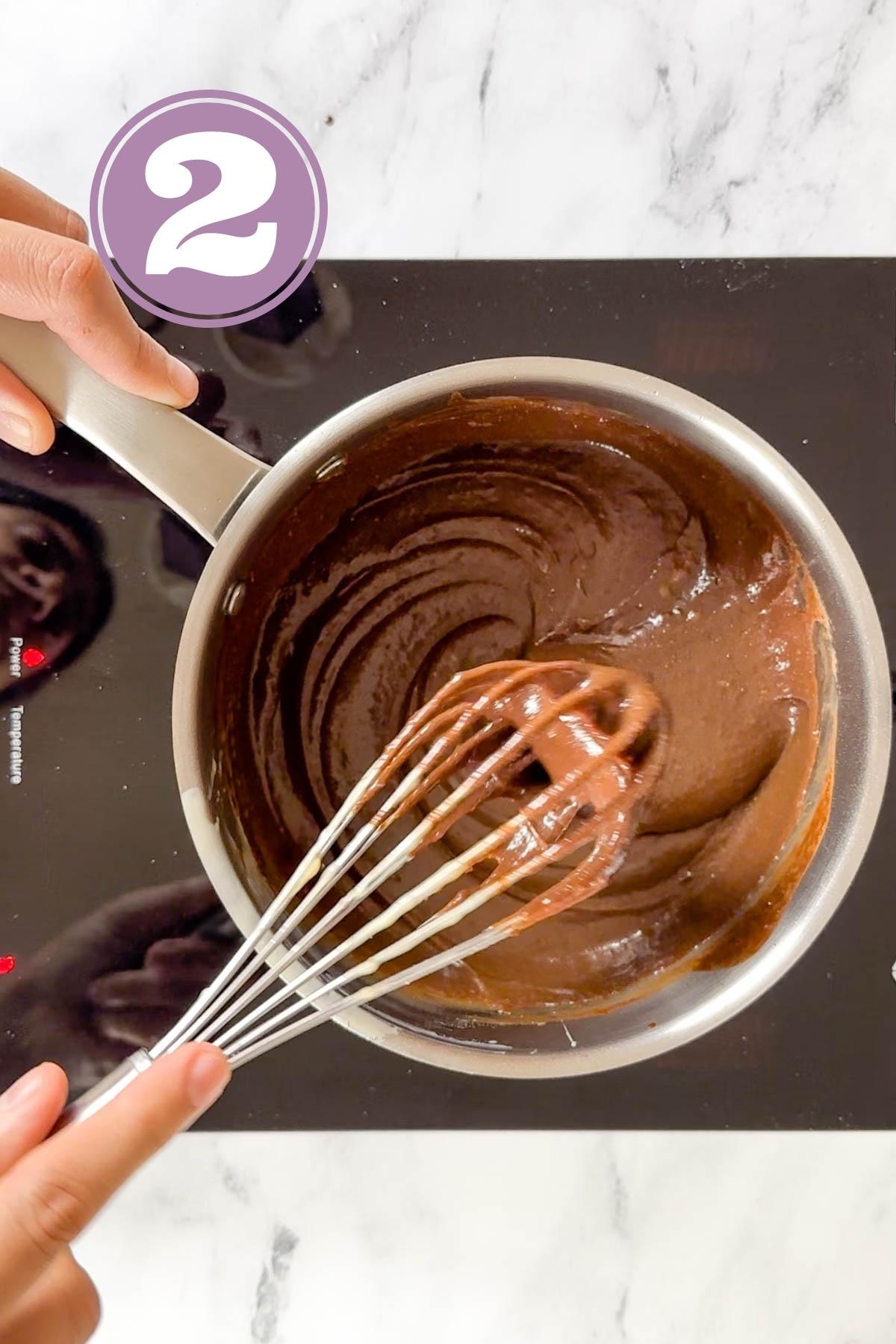 heating the chocolate and butter using a whisk.