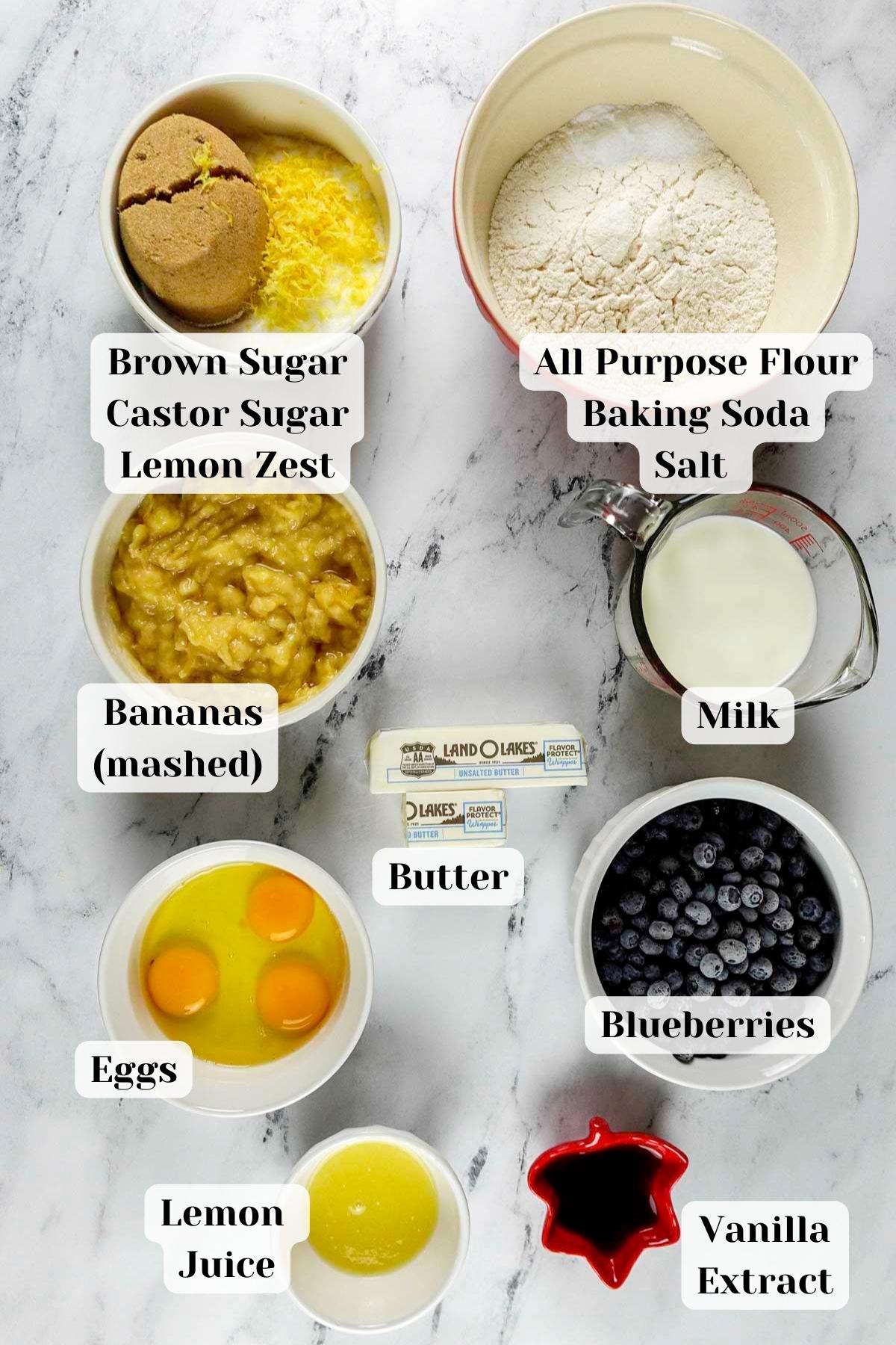 ingredients for blueberry banana cake placed on a marble slab.