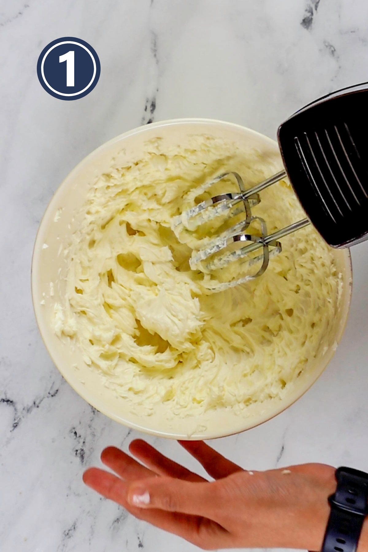 beating the butter and cream cheese together in a medium sized bowl.