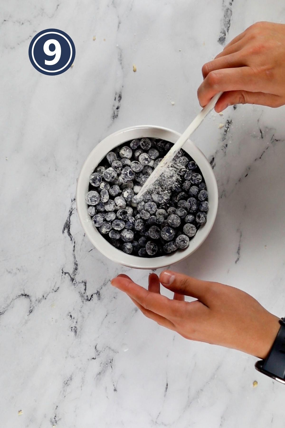 tossing the blueberries into one tablespoon of flour.