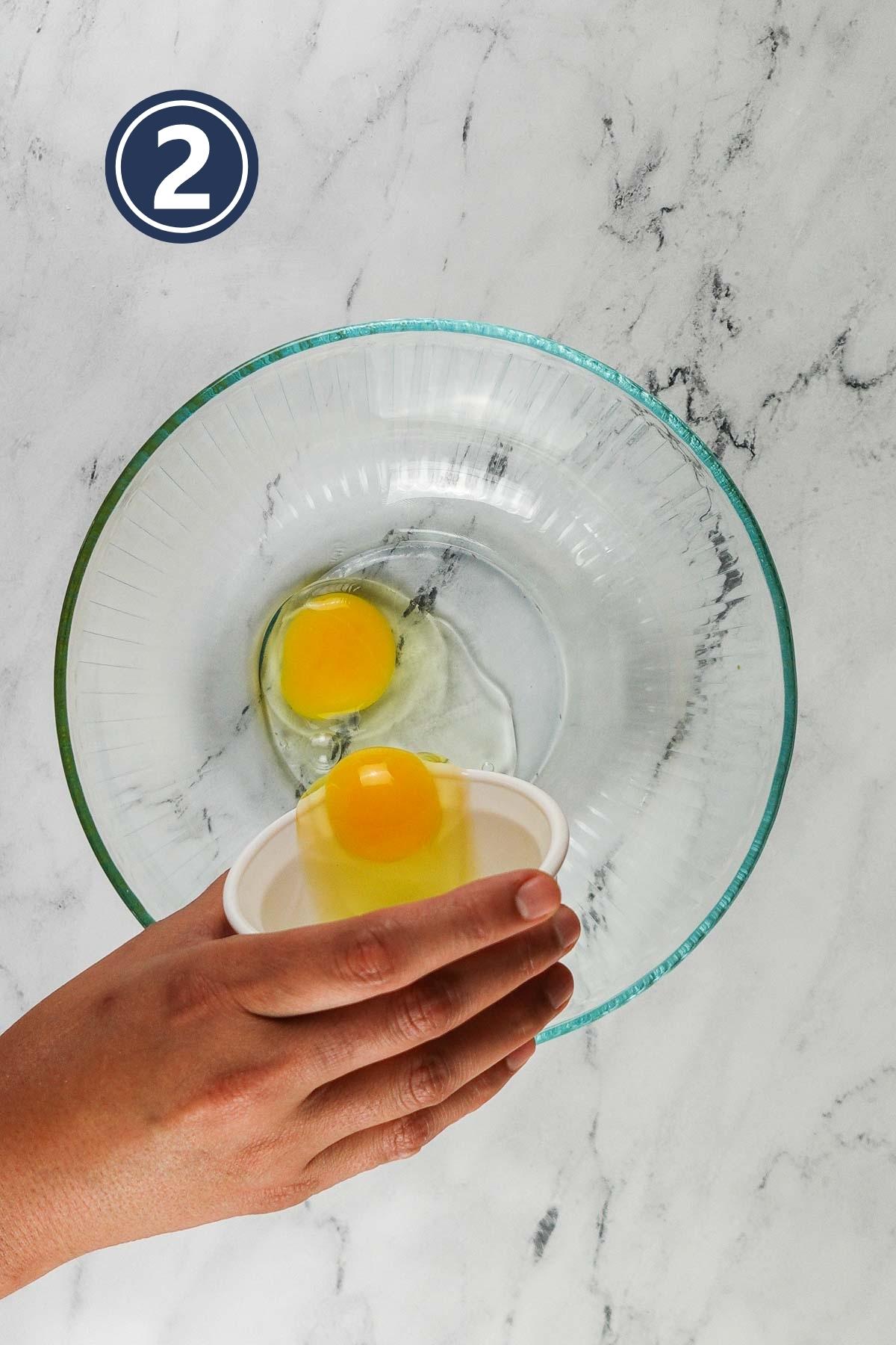 adding eggs in a large bowl.