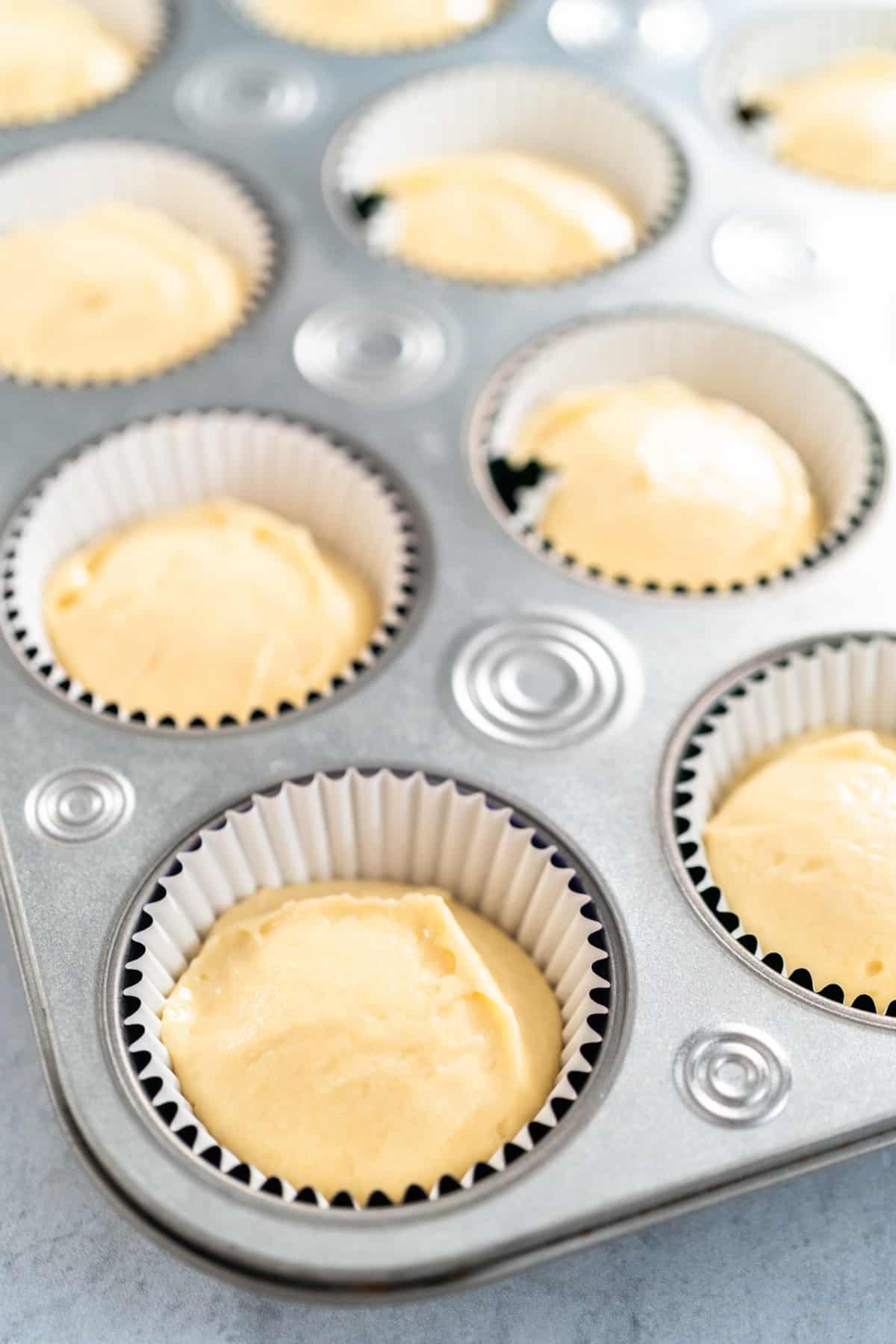 cupcake batter in the cupcake liners in the cupcake tin.
