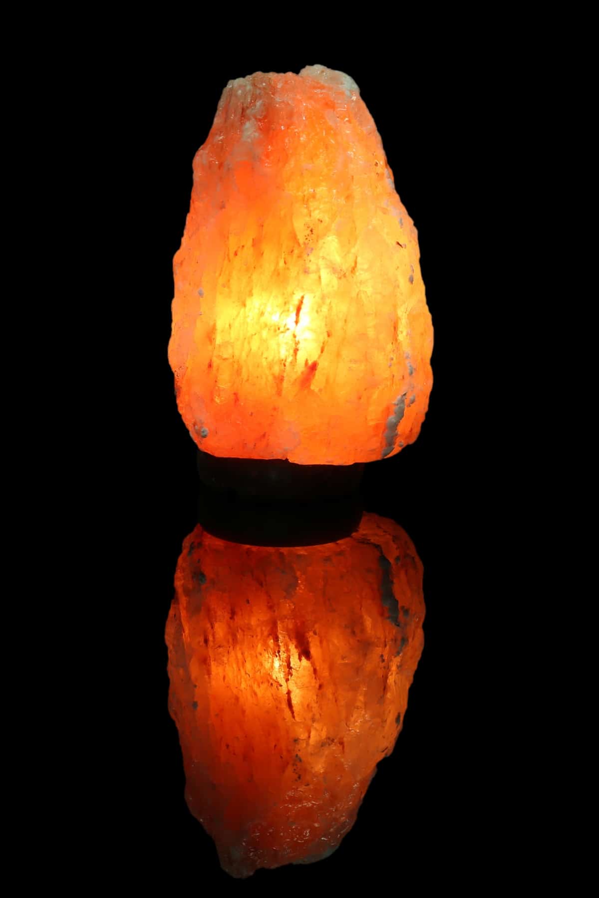 a lighted himalayan lamp with black background.