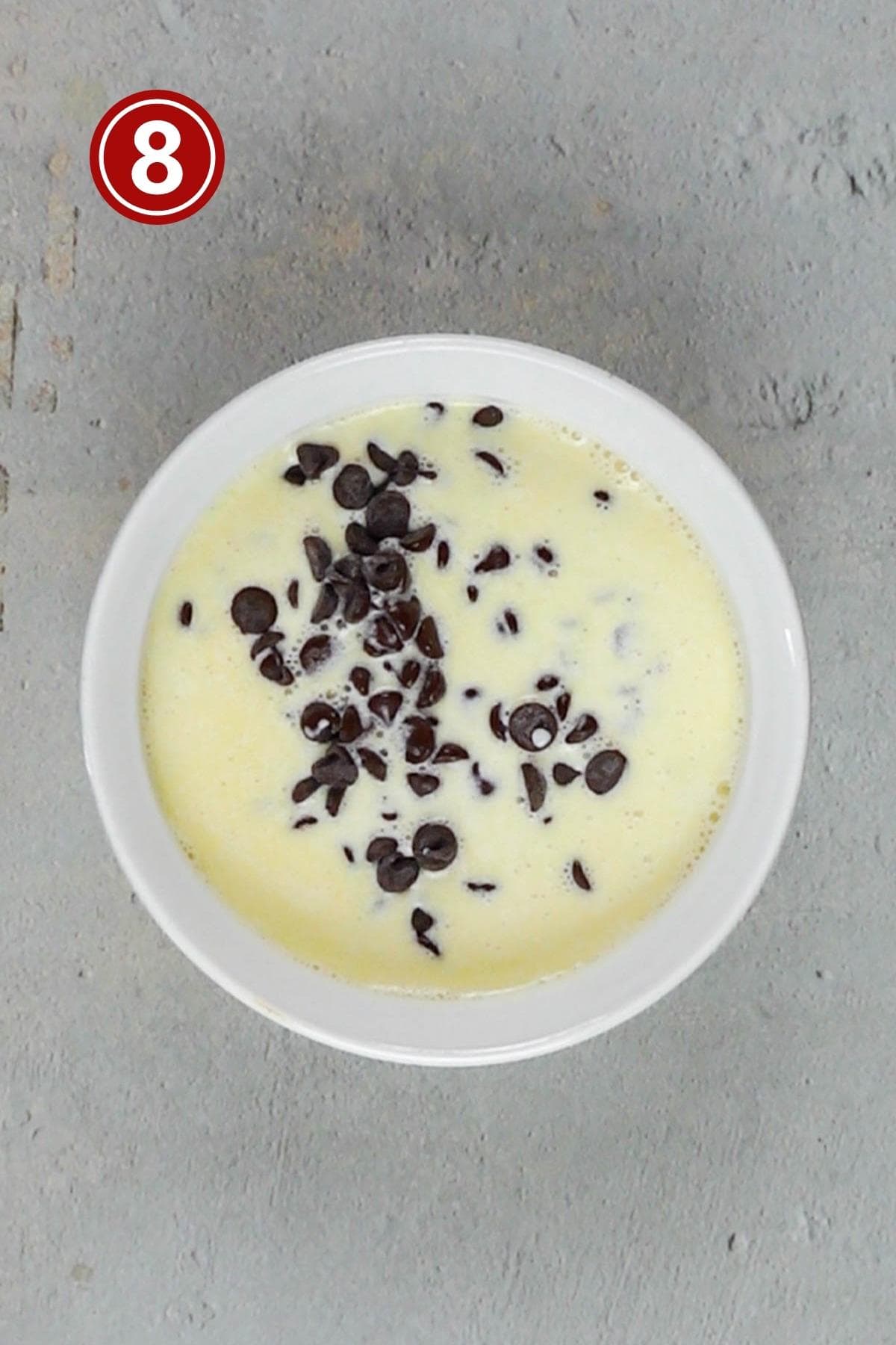 heavy cream and chocolate chips in a white bowl.