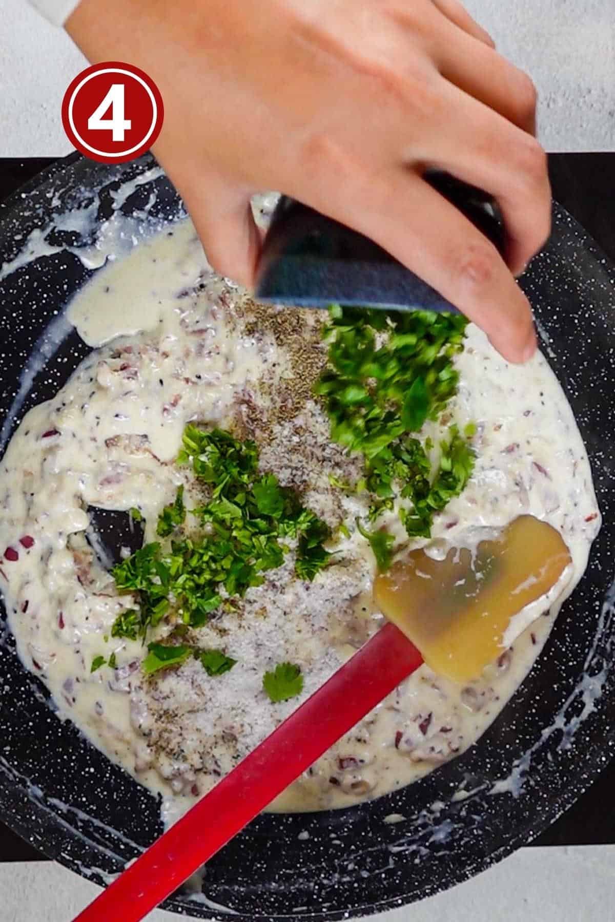 adding the coriander leaves into the cream mixture for the filling.
