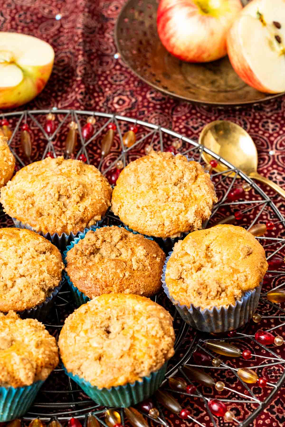 Apple muffins sitting in a plate with golden spoon on the side.