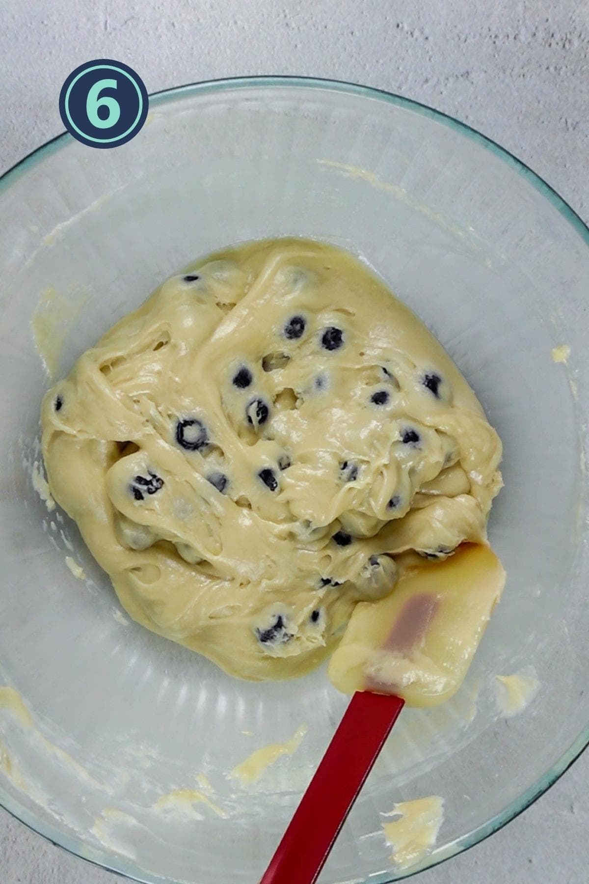 folding in the blueberries in the batter.