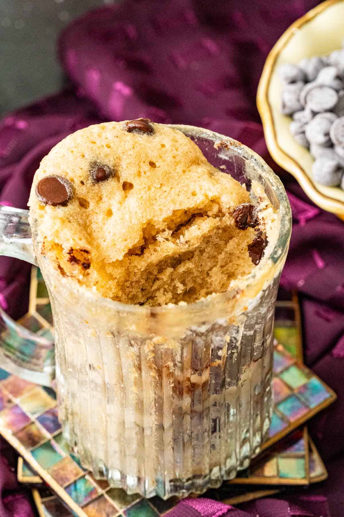 Chocolate mug cake in a transparent cup sprinkled with chocolate chips.